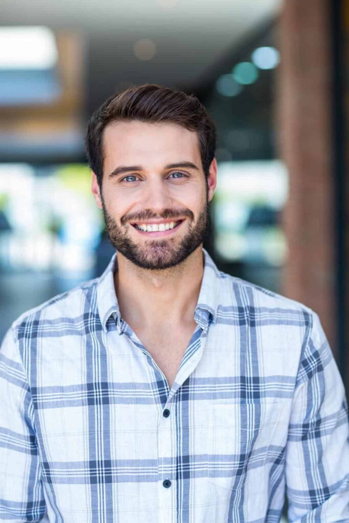 Tim Frechette wearing a blue plaid shirt in an indoor location